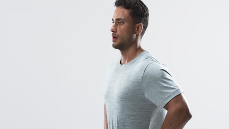 young biracial athlete man stands confidently in a studio setting on a white background