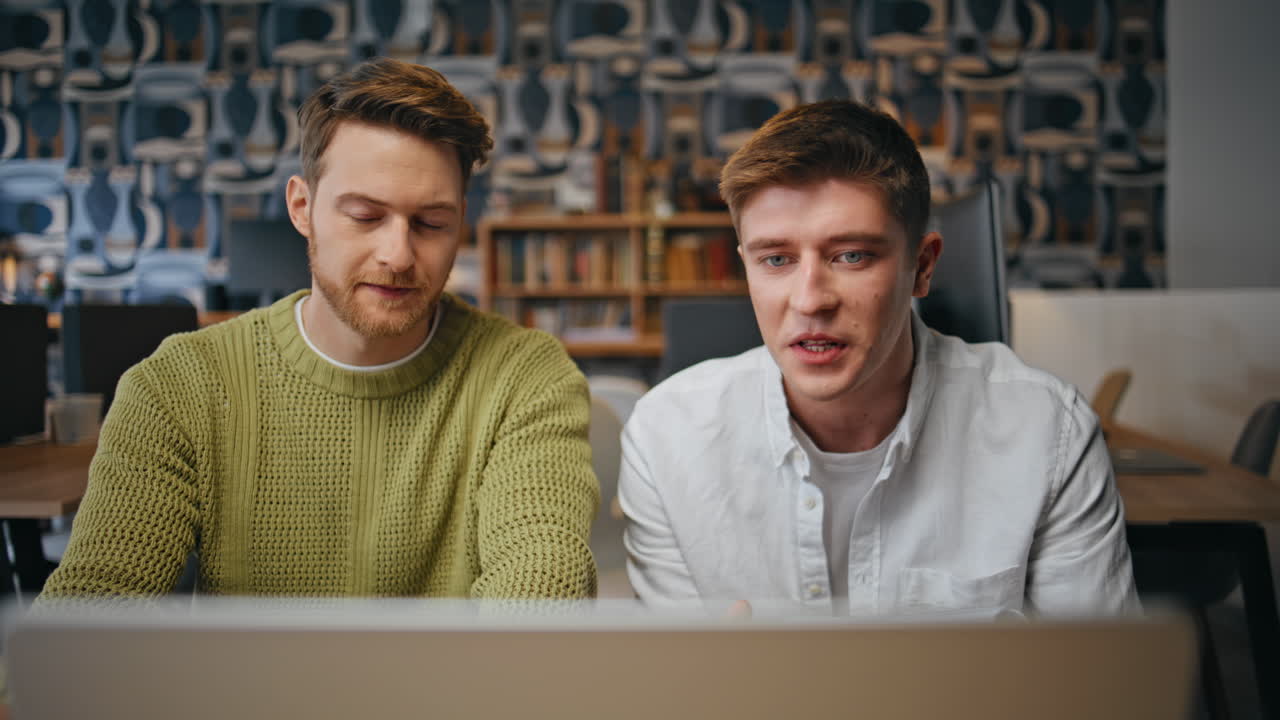 Positive men video talking leading presentation at office. Team online meeting