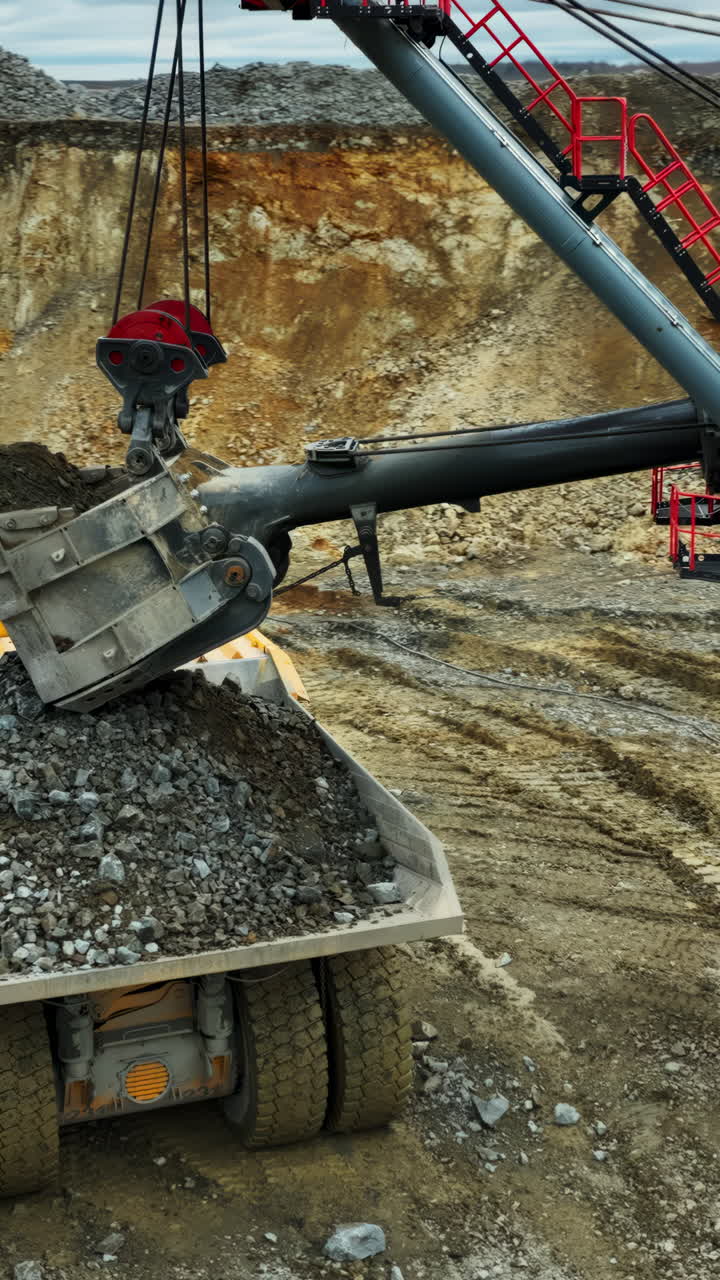 Giant Excavator Loading Dump Truck in an Open-Pit Mine