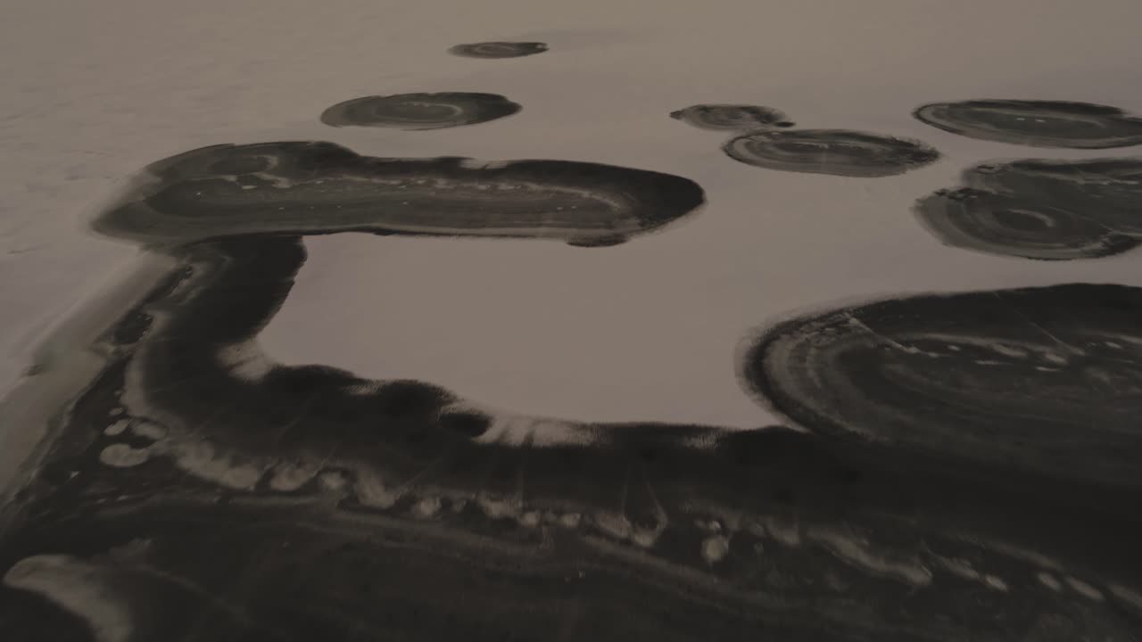 Descending and smoothly tilting to show the winter wonderland of Lake Michigan