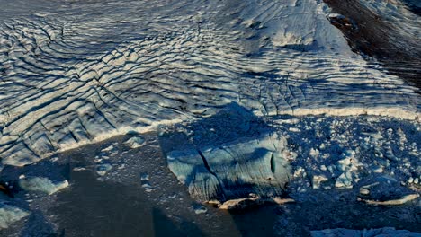 flying over lagoon in skaftafellsjokull glacier in iceland - drone shot