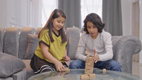 Indian-kids-arranging-wooden-blocks-to-make-Jenga-tower