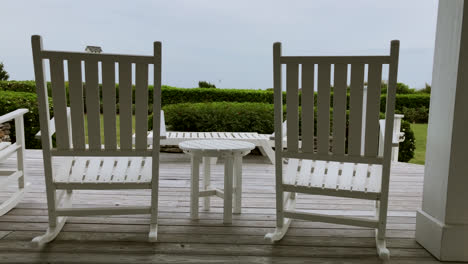 a set of outdoor rocking chairs swaying in the wind