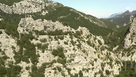 Aerial-Revealing-shot-of-a-mountain-on-a-hot-summer-day-in-Croatia