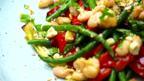 roasted green and white beans on a plate rotating