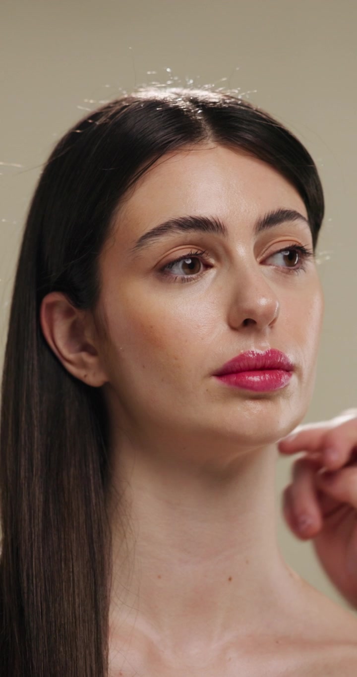 Professional Makeup Artist Applying Finishing Touches to Model