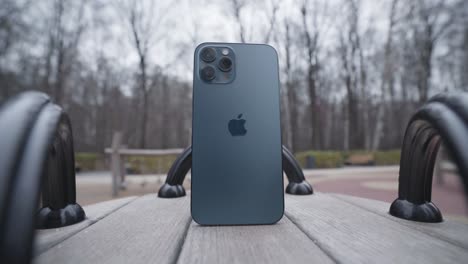 dark blue iphone on a park bench