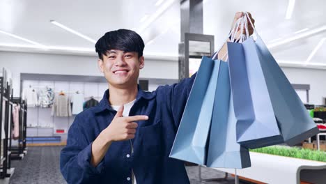 happy man shopping in a mall