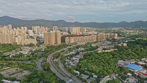 drone flight over highway in rural area of tin shui wai new town, hong kong