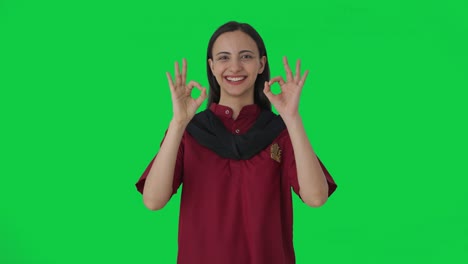 Happy-Indian-female-housekeeper-showing-okay-sign-Green-screen