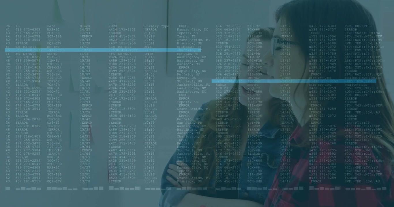 Two women studying sticky notes upon code overlay appearing and circling note in business project