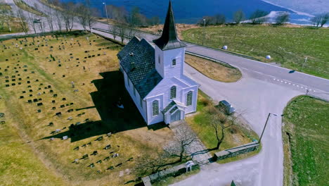 white color church on lake coastline, aerial drone view