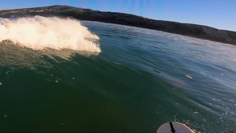 surfer catching wave and doing some snaps and carvings in beach, portugal