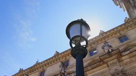 streetlight in courtyard of louvre museum in paris, france.