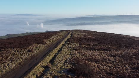 cloudy misty sunrise valley low aerial moorland hiking hillside muddy path lancashire pull back