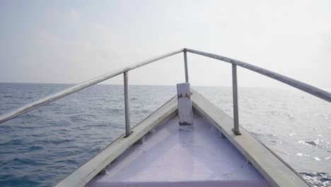 looking out over the starboard of an andaman fishing boat as it points out to the andaman sea in the afternoon sun