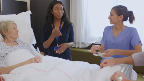 senior patient and medical staff in consultation at hospital