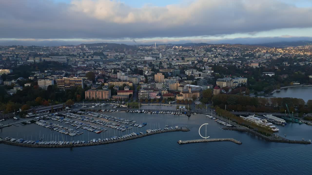 Dolly in drone shot over Ouchy Port in Lausanne at sunset in Switzerland