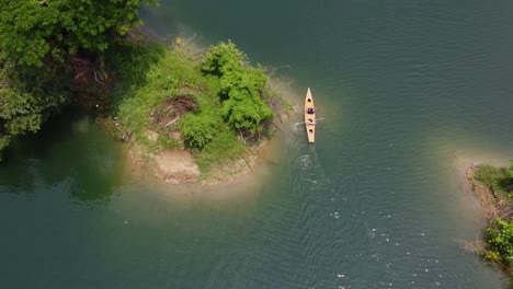 drone shot of kayaking on blue lake water on a bright sunny day