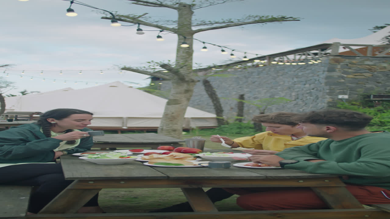 Tourists Having Dinner Together at Glamp