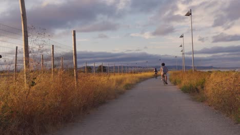 An-Indie-Scene-of-Guys-Riding-their-Bicycles-during-Golden-Hour-in-the-outskirts-of-Lisbon,-Portugal