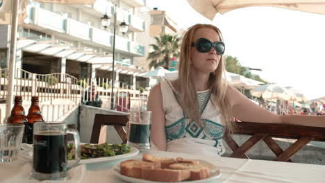 young woman having a meal in an outdoor restaurant