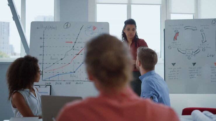Business female coach teaching employees in modern office