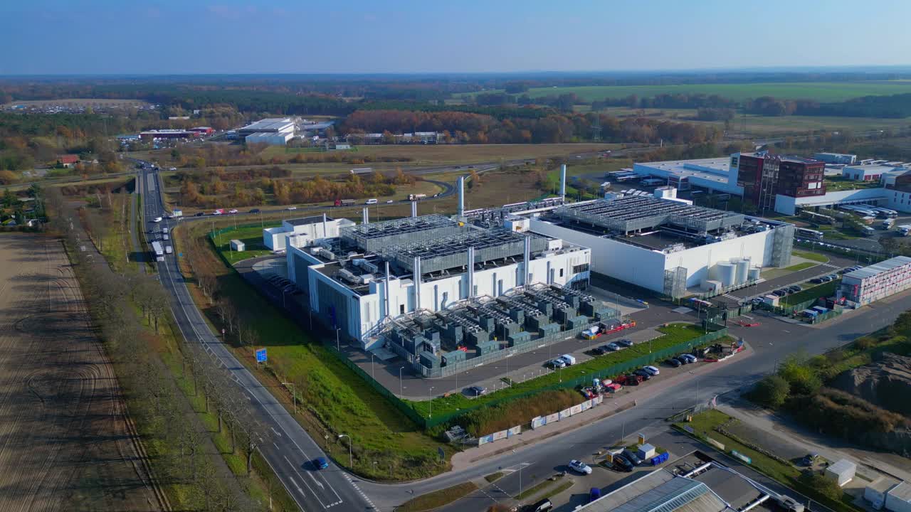 Modern big data center facility standing in an industrial area, serving digital information and connectivity. Fantastic aerial view flight ascending raise up panorama orbit drone