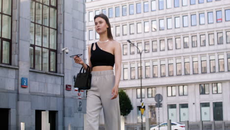 young fashionable woman walking down the street