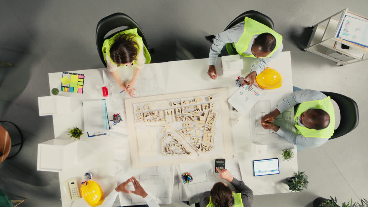 Vertical Video Top down view zoom in of architects working on real estate investment plan