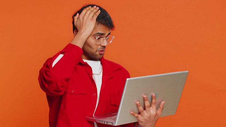 Displeased indian man use laptop surprised by bad news fortune loss game fail lottery results