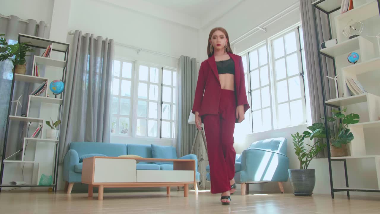 Young Fashion Transgender Woman Wearing Red Clothes Walking And Posing In Home