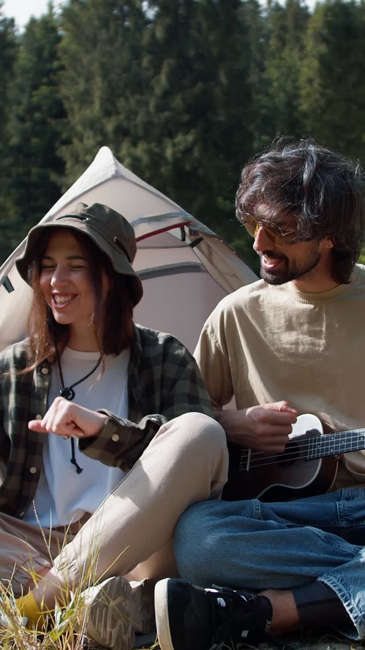 Couple Camping and Playing Ukulele