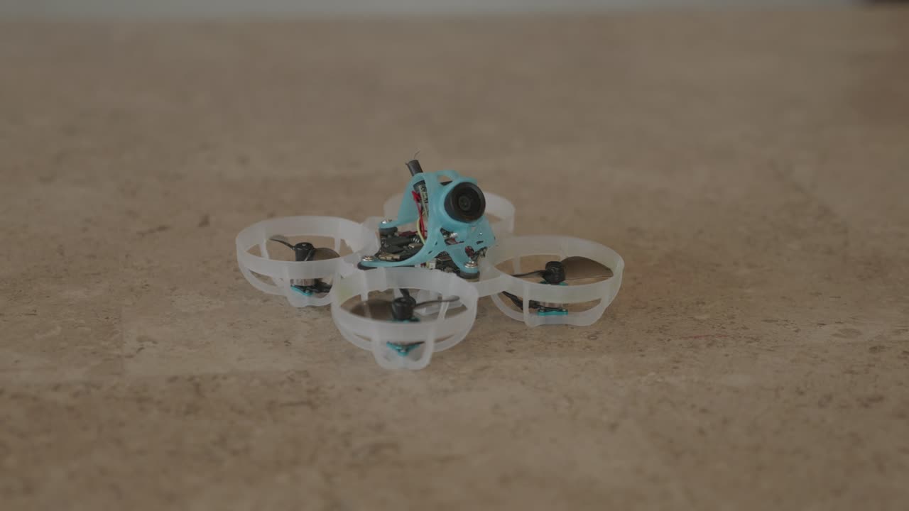 Slow spin to the right showcasing a tiny whoop FPV drone