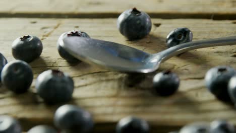 fresh blueberries and spoon on wooden table 4k