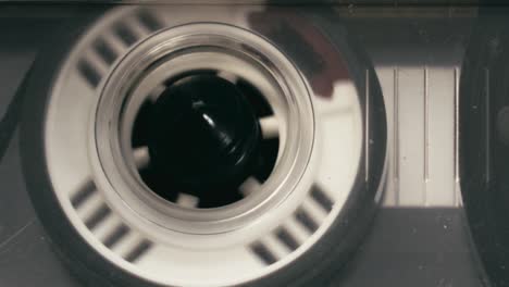 close-up shot of cassette player audio recording tape turning