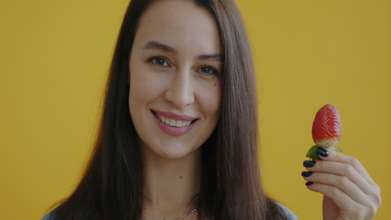 Woman Holding a Strawberry