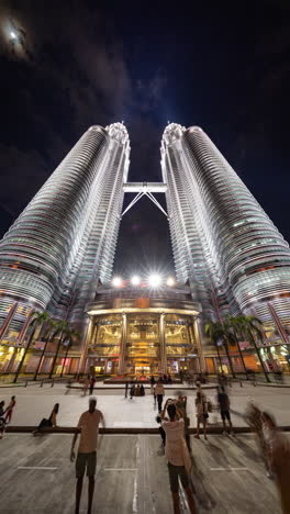 kuala lumpur, malaysia - 29 march 2025 : wide angle timelapse of the petronas towers in kuala lumpur in vertical at night