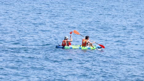 two people kayaking in sorrento, naples, italy