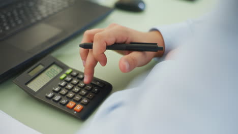 Shot of Hand Counting on Calculator