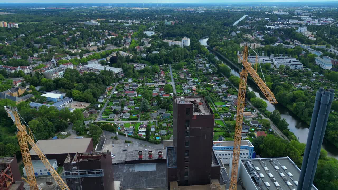 2 crane dismantling a power plant during a demolition process. Majestic aerial view flight tilt up drone