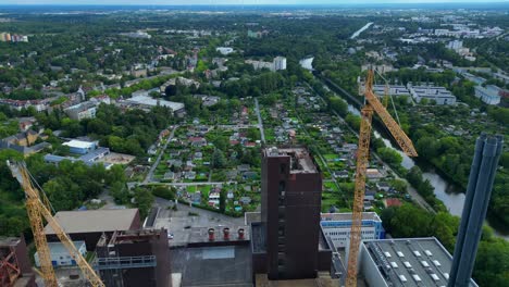 2 crane dismantling a power plant during a demolition process. majestic aerial view flight tilt up drone