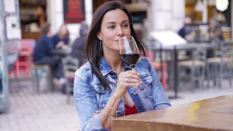 woman enjoying a glass of red wine outdoors