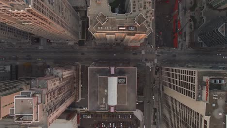 4k aerial shot looking down on the city streets in a dense downtown neighborhood