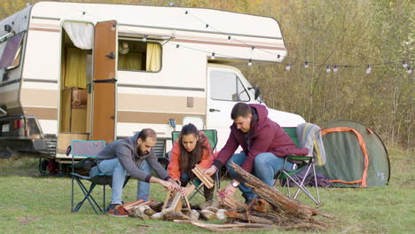 Friends-setting-up-the-wood-for-camp-fire