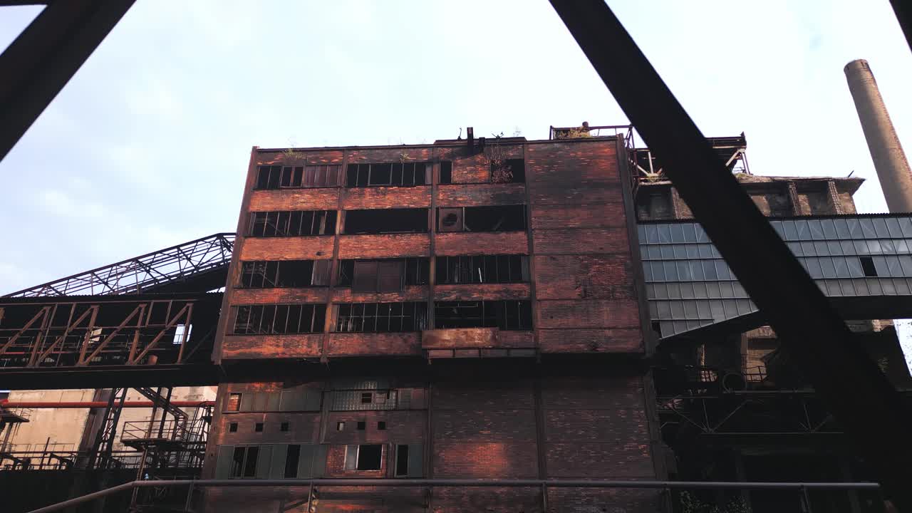 Industrial abandoned red brick building in a large area of old blast furnaces