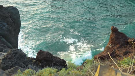 POV-on-top-of-cliff-watching-ocean-waves,-high-angle-static