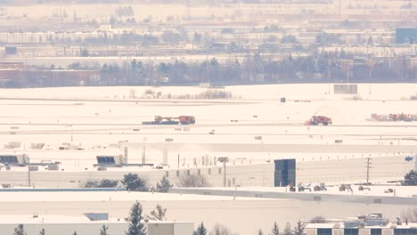 wide steady view of trucks clearing snow from road in toronto, canada