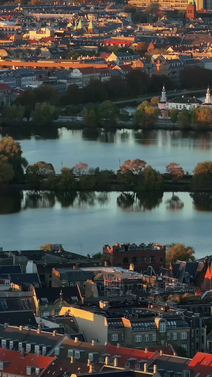 Aerial drone view of the Lakes curving around the western margin of the city centre of Copenhagen, Denmark. Vertical