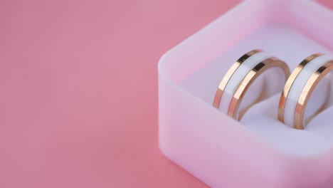 elegant gold and white earrings in a pink box